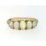 A yellow gold and five stone opal and diamond ring, finger size O.