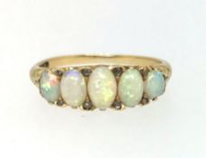 A yellow gold and five stone opal and diamond ring, finger size O.