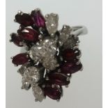 A fine 18ct white gold ruby and diamond cluster ring, finger size K.