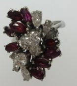 A fine 18ct white gold ruby and diamond cluster ring, finger size K.
