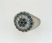 An 18ct blue and white diamond set ring.