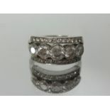 An 18ct white gold channel set diamond ring, finger size L.
