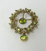 A 9ct gold flower design peridot and pearl drop brooch, approx 5.40gms.