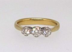 A 18ct diamond three stone ring, stamped 750, .33, finger size O.