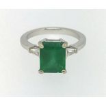 An 18ct emerald and diamond ring.
