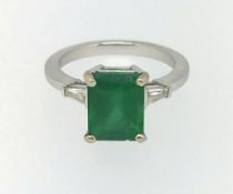 An 18ct emerald and diamond ring.