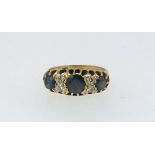 An 18ct sapphire and diamond ring, finger size L.