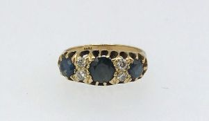 An 18ct sapphire and diamond ring, finger size L.