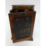 An early 20th Century carved oak smokers cabinet, height 28cm, width 20cm, fitted with a single