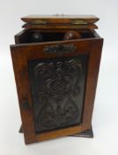 An early 20th Century carved oak smokers cabinet, height 28cm, width 20cm, fitted with a single
