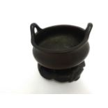 A Chinese bronze censer and stand, height excluding stand 10cm, diameter 14cm,