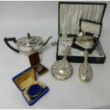 A silver napkin ring, silver back clothes brush, a four piece silver back dressing table set, cased,