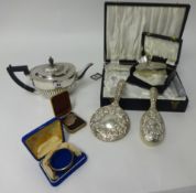 A silver napkin ring, silver back clothes brush, a four piece silver back dressing table set, cased,