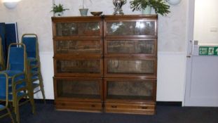 A pair of oak Globe Wernicke bookcases each with four sections.