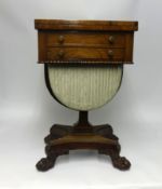 A good Regency rosewood sewing/games table, supported on a hoop frame with carved feet and