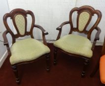 A pair of Victorian style mahogany framed elbow chairs.