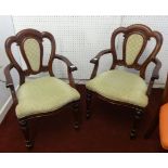 A pair of Victorian style mahogany framed elbow chairs.