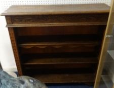 A free standing carved oak bookcase with adjustable shelves (later back).