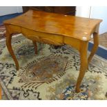 A walnut side table, the shaped top fitted with a single drawer over cabriole legs