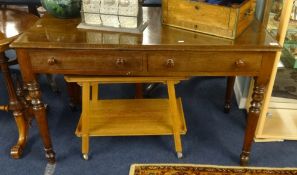 A late Victorian writing table fitted with two drawers over turned legs