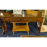 A late Victorian writing table fitted with two drawers over turned legs