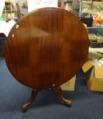 A Victorian mahogany circular breakfast table with tip up top, diameter 102cm, together with three