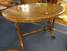 Victorian walnut oval side table with carved stretcher base.