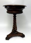 A William IV rosewood Teapoy, with a fitted interior twist pedestal base, diameter 50cm.