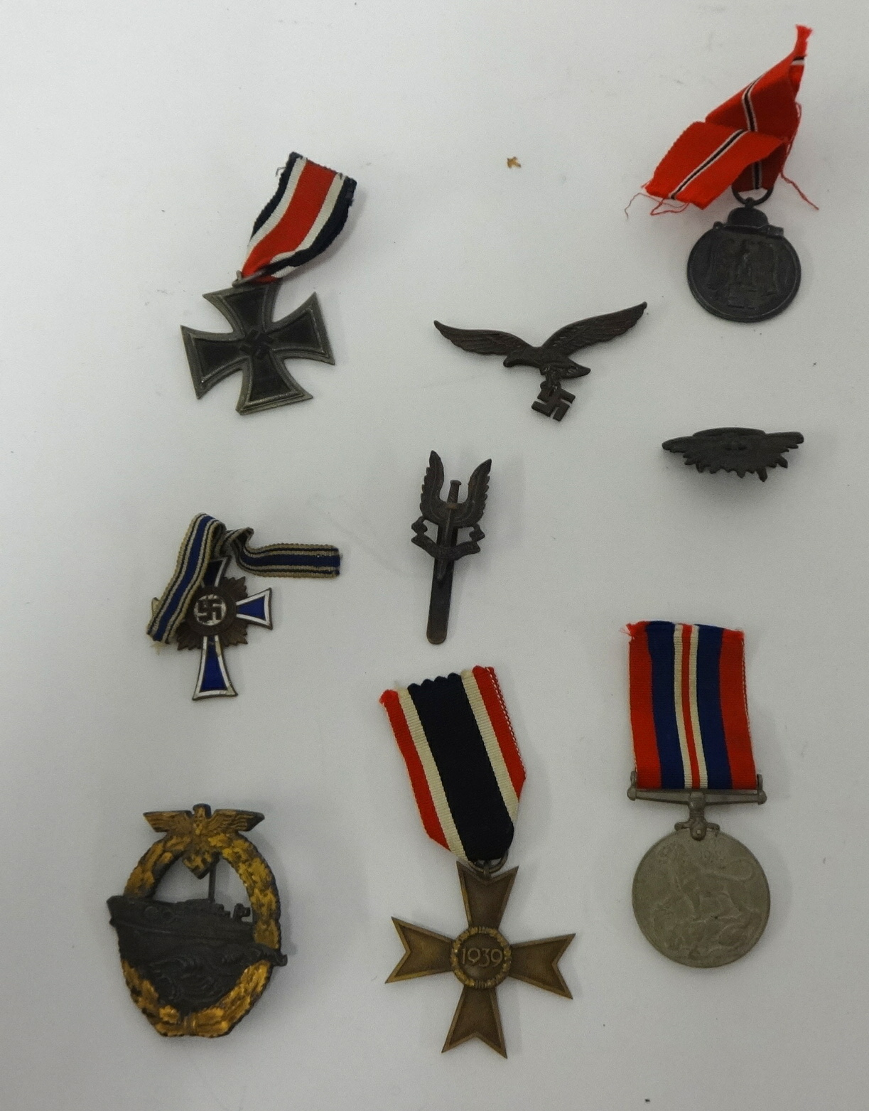 Various medals including German Mothers Cross, Iron Cross, other German badges and cap badges (9).