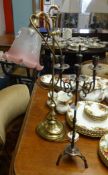 A rising brass table lamp with glass shade and a metal candelabra (2).