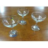 A collection of thirteen Babycham glasses.