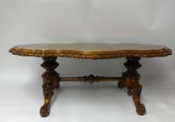 A good burr walnut coffee table with carved walnut stretcher base, width 128cm, height 46cm.