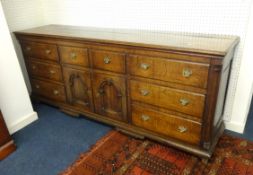 A large Georgian oak Lancashire dresser base fitted with an arrangement of eight drawers and a