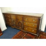 A large Georgian oak Lancashire dresser base fitted with an arrangement of eight drawers and a