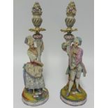 A pair of late 19th Century bisque figure candle holders, height 47cm, together with a pair of