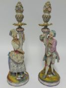 A pair of late 19th Century bisque figure candle holders, height 47cm, together with a pair of