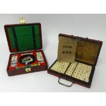 A modern mah-jong set and a travel roulette set (2).