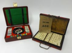 A modern mah-jong set and a travel roulette set (2).