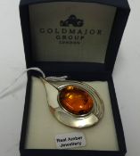 A modern silver and amber contemporary brooch.