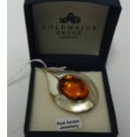 A modern silver and amber contemporary brooch.