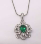 A pretty emerald and diamond pendant and chain.