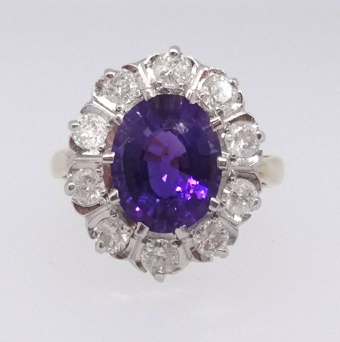 An 18ct bright amethyst and cluster diamond ring, the setting approx 16mm x 14mm, ring size P.
