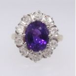 An 18ct bright amethyst and cluster diamond ring, the setting approx 16mm x 14mm, ring size P.