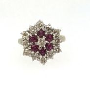 A fine ruby and diamond target ring set in yellow gold, unmarked, ring size O/P.