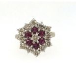 A fine ruby and diamond target ring set in yellow gold, unmarked, ring size O/P.