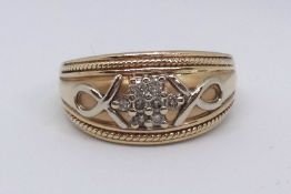 A 14ct Bombay shaped dress ring with a plied loop motif and wire trim to the edges, further set with