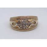 A 14ct Bombay shaped dress ring with a plied loop motif and wire trim to the edges, further set with