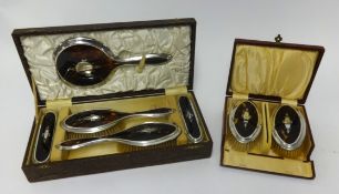 A five piece silver and tortoise shell inlaid dressing table set together with a pair of similar