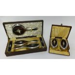 A five piece silver and tortoise shell inlaid dressing table set together with a pair of similar
