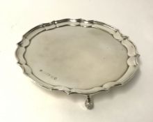 A modern silver salver with shaped border on scroll feet, maker 'P.B', diameter approx 26cm,